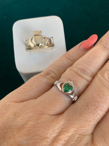 green birthstone claddagh ring on finger