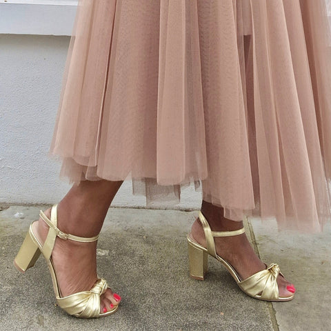 wide fit heeled sandals in gold leather styled with a dusky pink tulle skirt