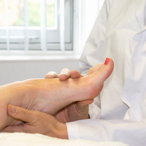 stretching the foot to ease pain from having flat feet