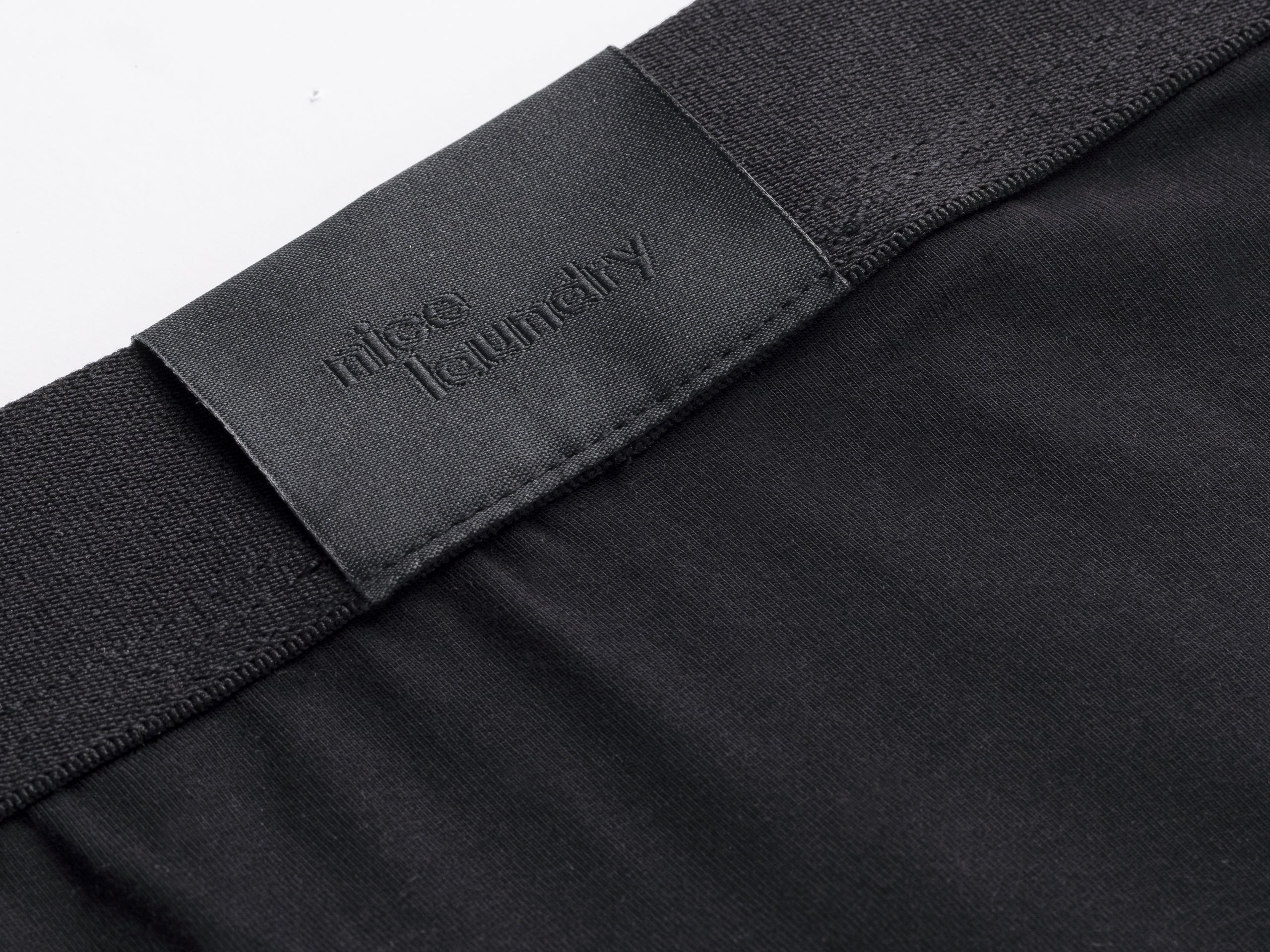 Close up detail shot of boxer brief label in Black.