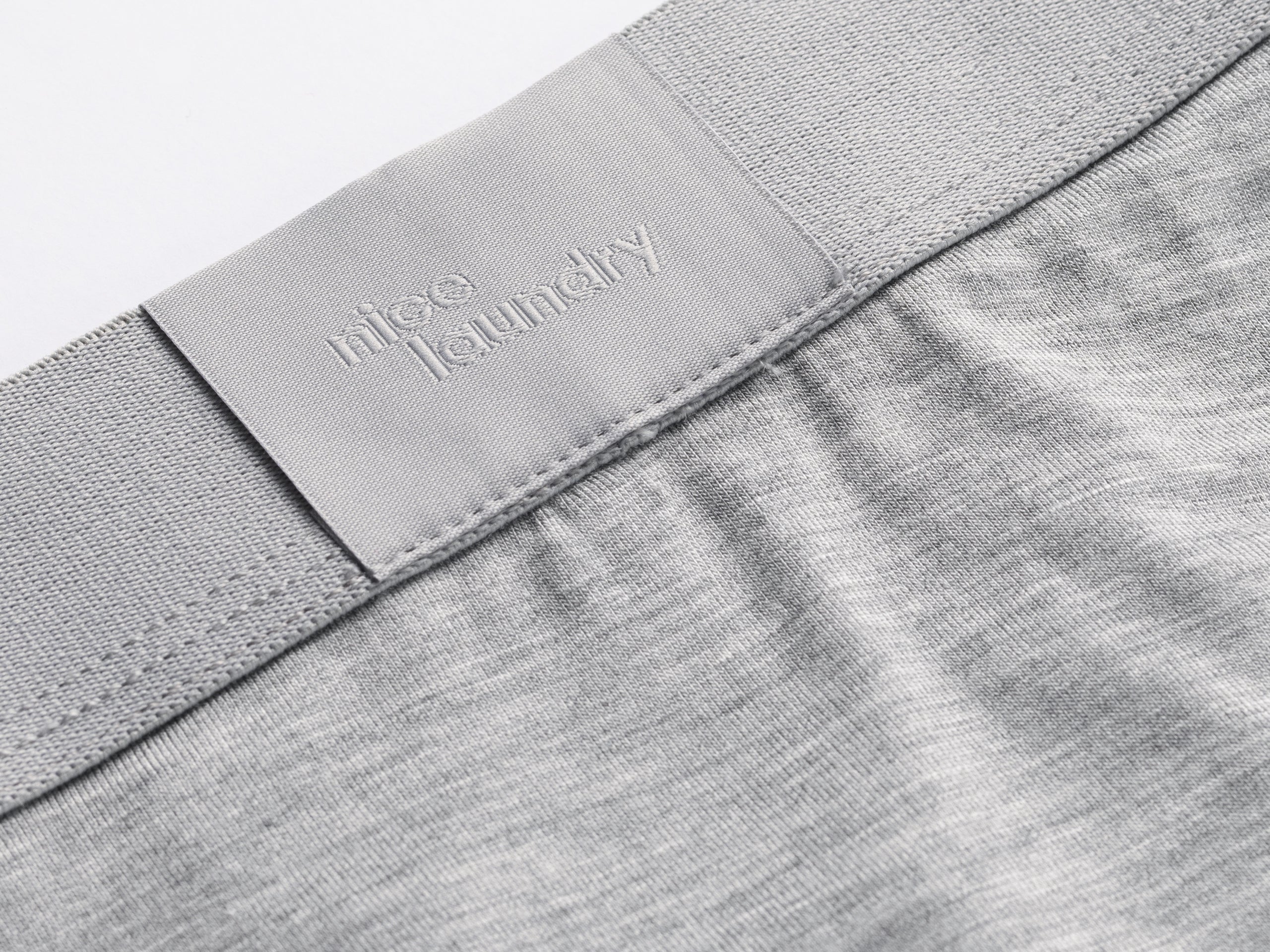 Close up detail shot of label on heather grey boxer brief.