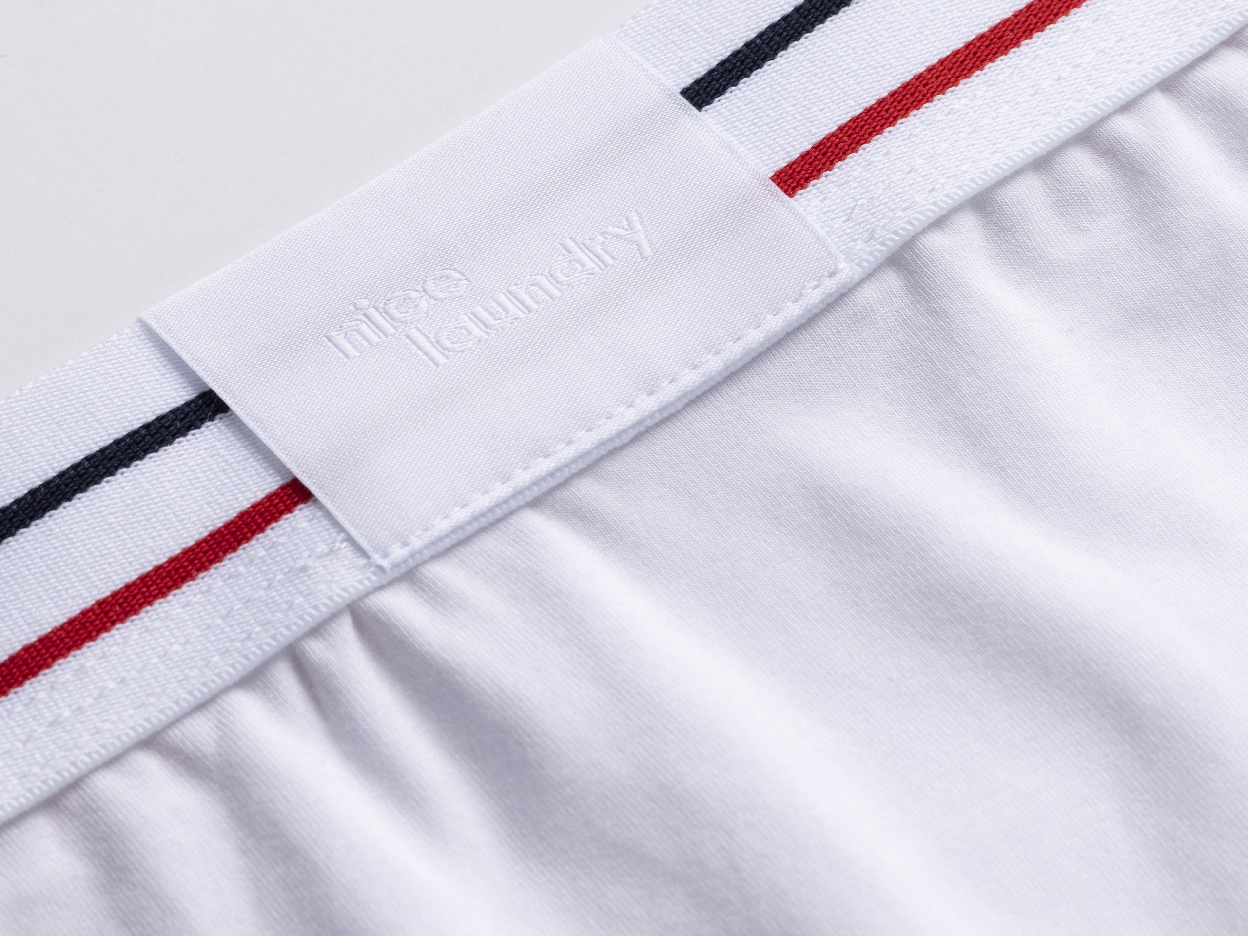 Close up detail shot of red white and blue stripe waist band found on brief.
