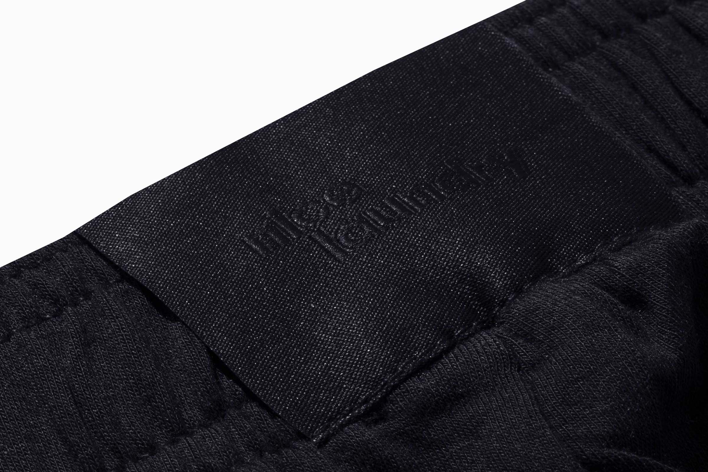 Close up detail shot of label on black pants