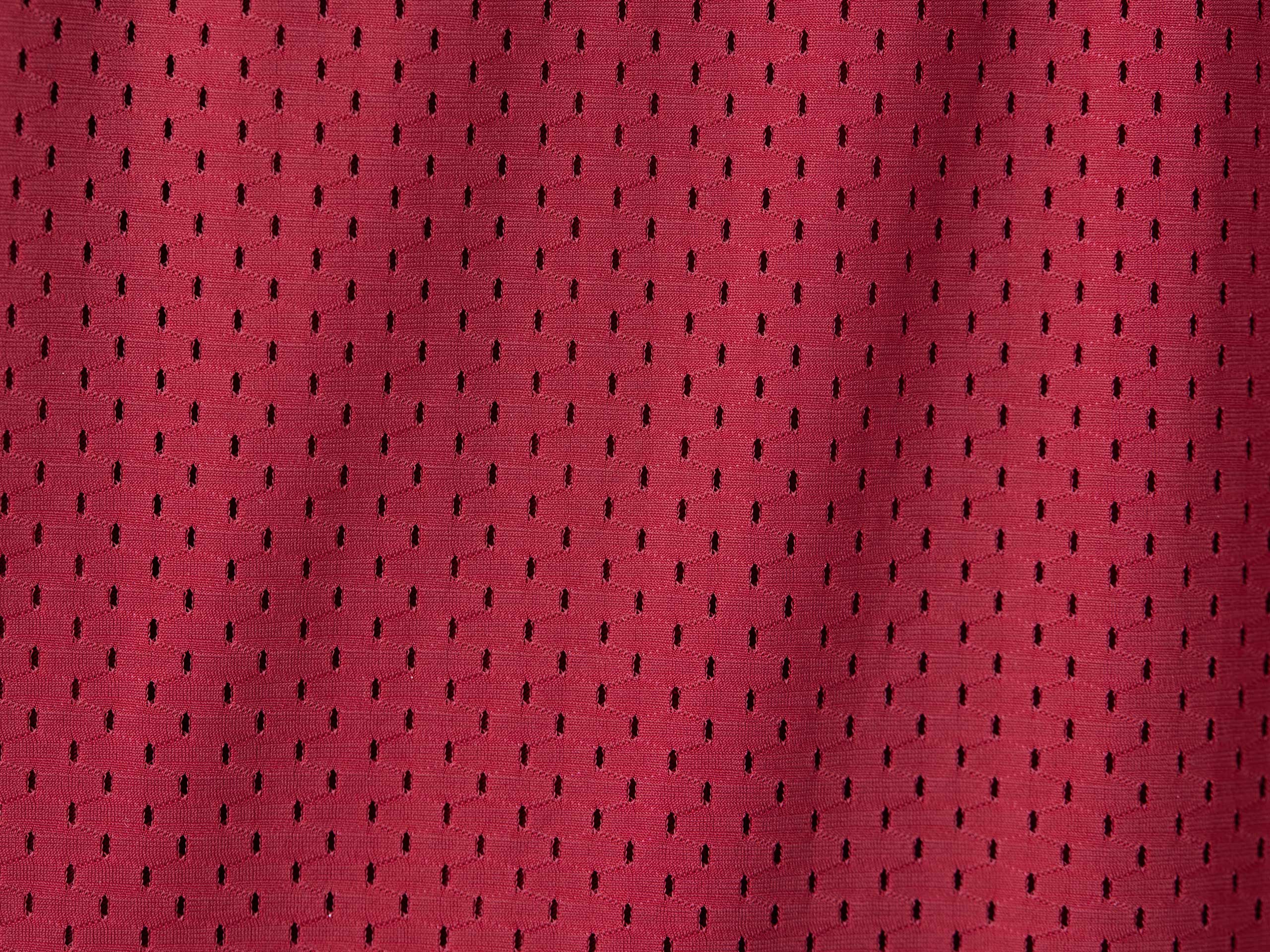 Close up detail shot of burgundy mesh texture.