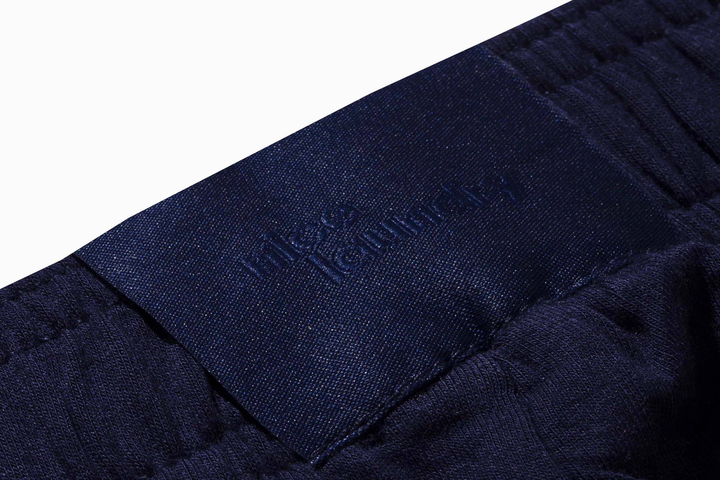 Detail shot of label on navy blue pant