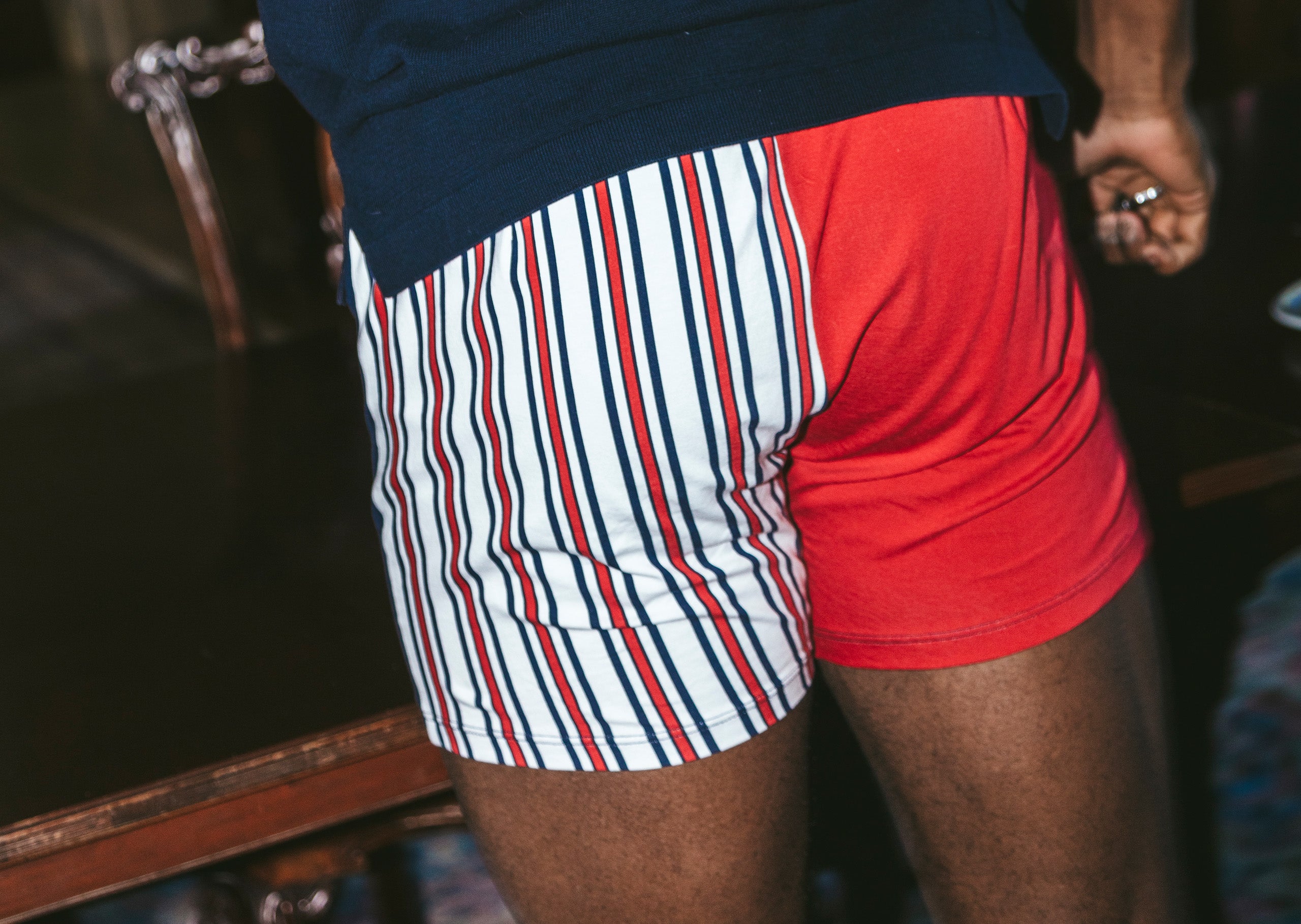 Close up back shot of man wearing blue shirt and red/white/blue stripe Regatta slim fit boxer.