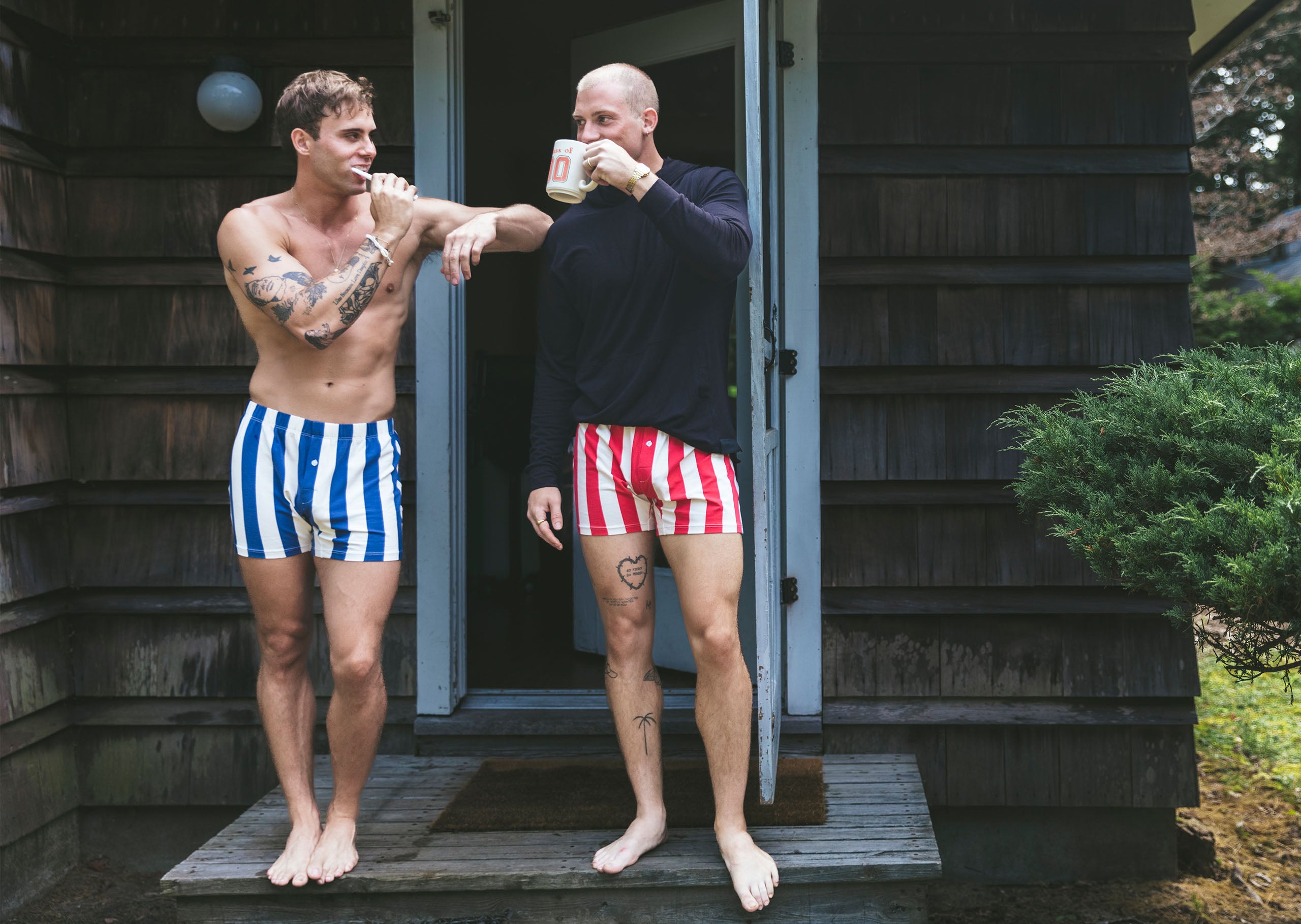 2 men standing in front of a home wear striped slim fit boxers.