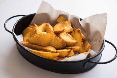 Potato wedges in a cast iron baking pan