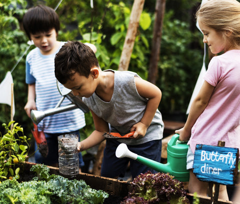 kids learning new skills through gardening outside