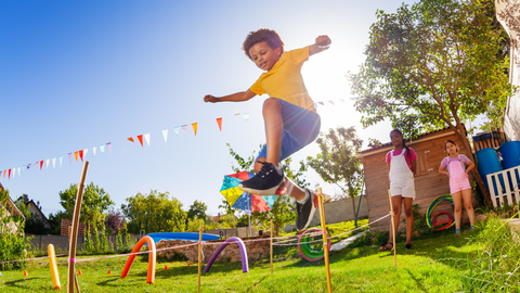 kids playing in a backyard obstacle course