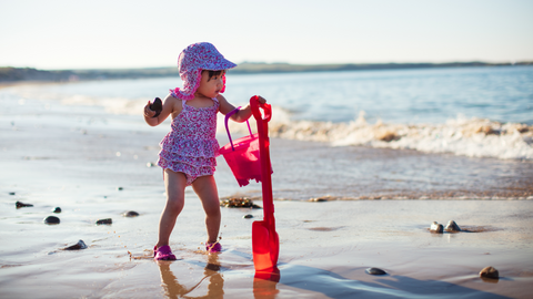 baby playing at the beach