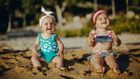 two babies in cute beach attire