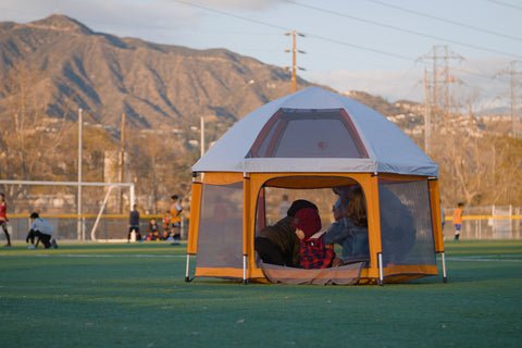 Family playing together in the portable playpen 