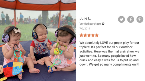 Triplet siblings enjoying their pop n go tent outside at a neighborhood event