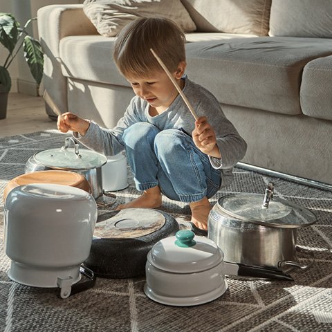 boy playing with pots and pans