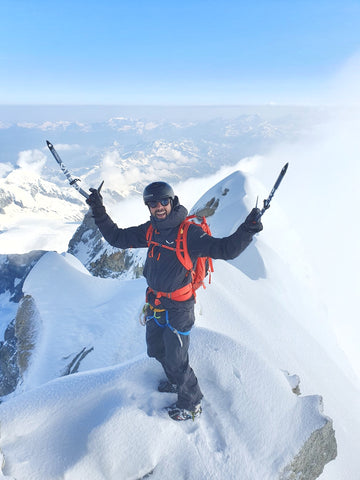 arnaud cottet with his moiry glacier optics sunglasses on the top of the weisshorn, 4506 meters above sea