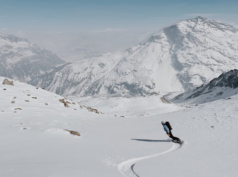 michel kropf snowboarding in the swiss alps and enjoying the beautiful mountains while doing a road trip