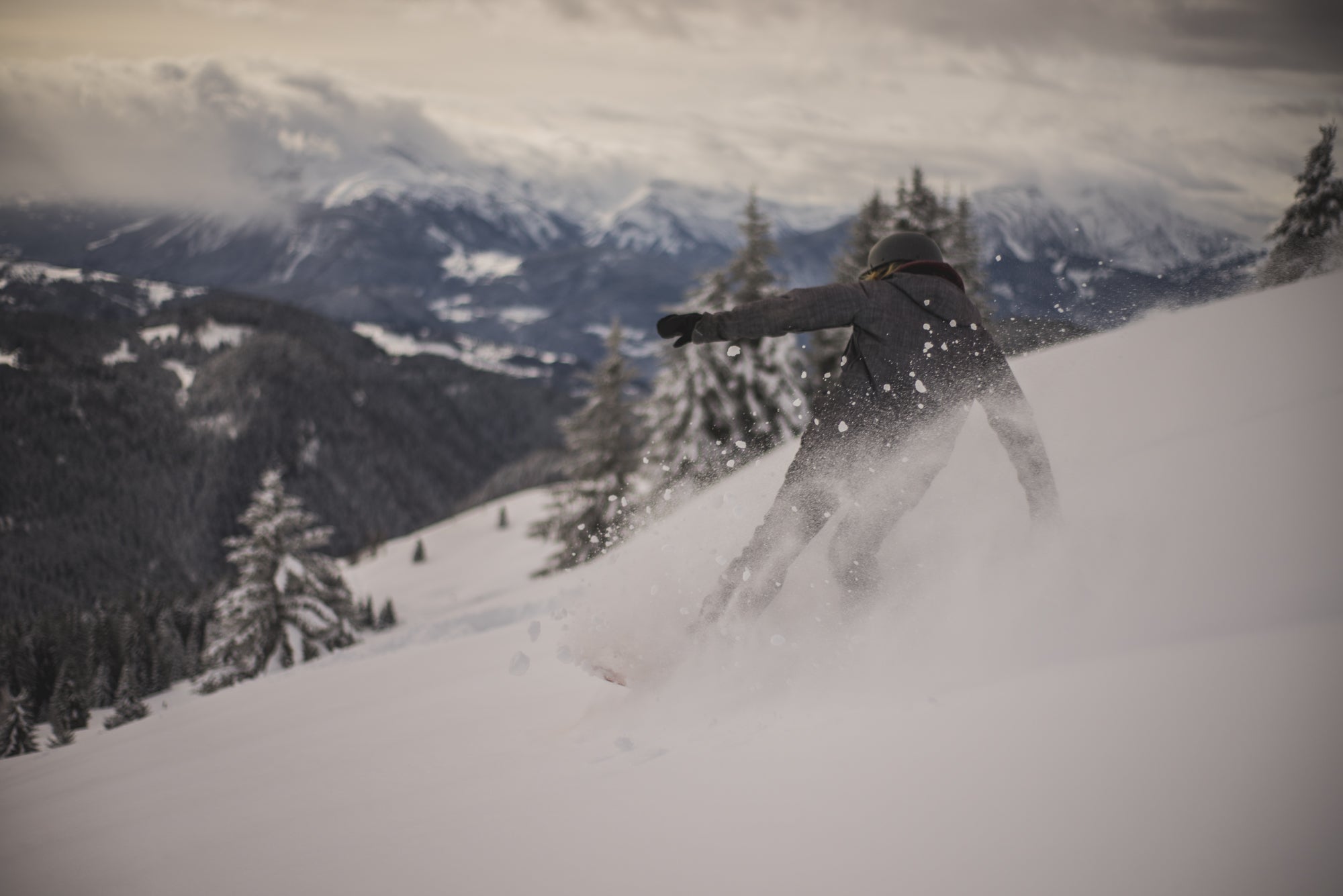 Girl snowboarding down mountain