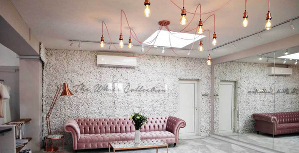 Floral wall bridal shop interior design with industrial lights