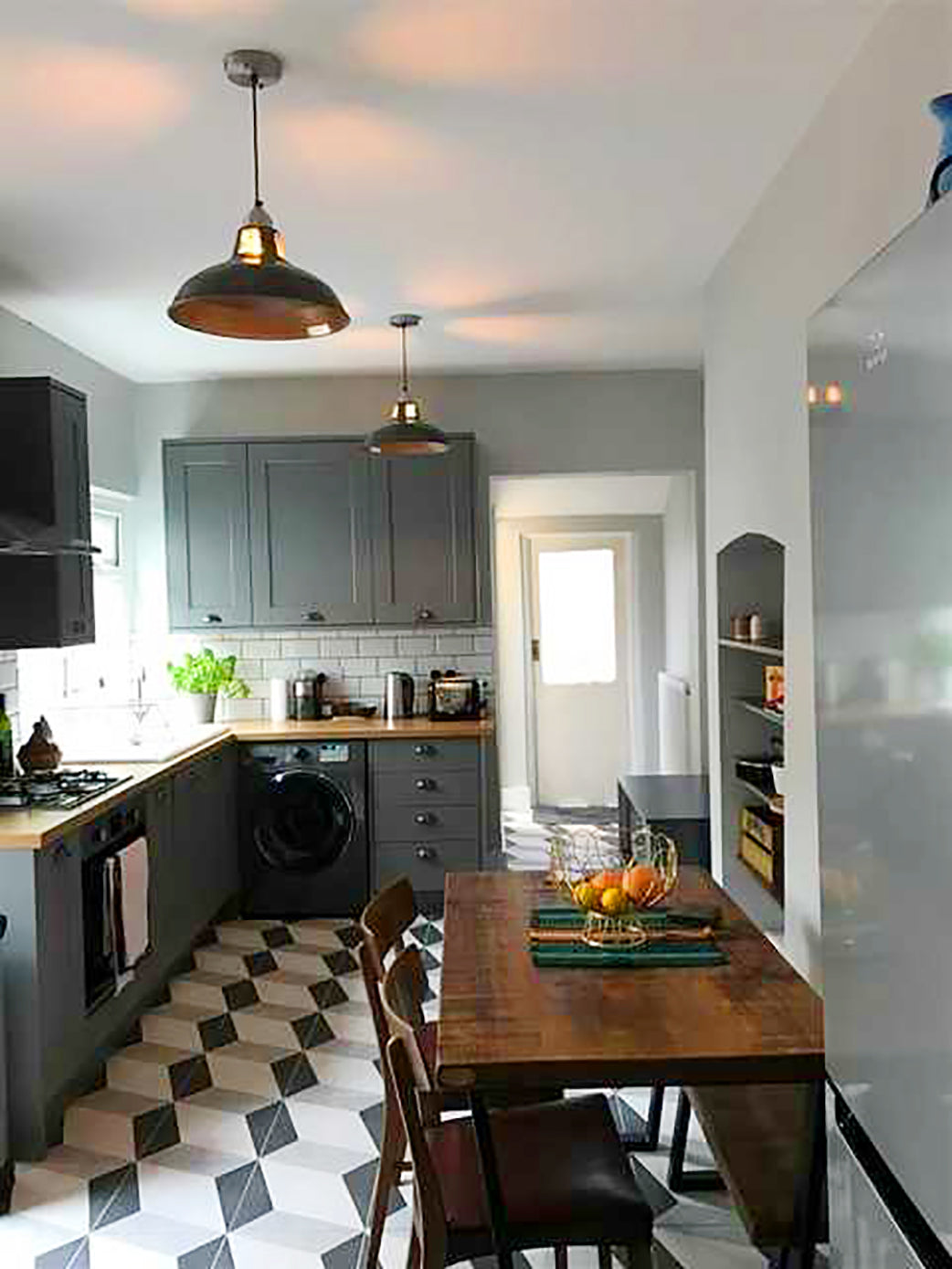 Funky patterned floor in kitchen with retro lights