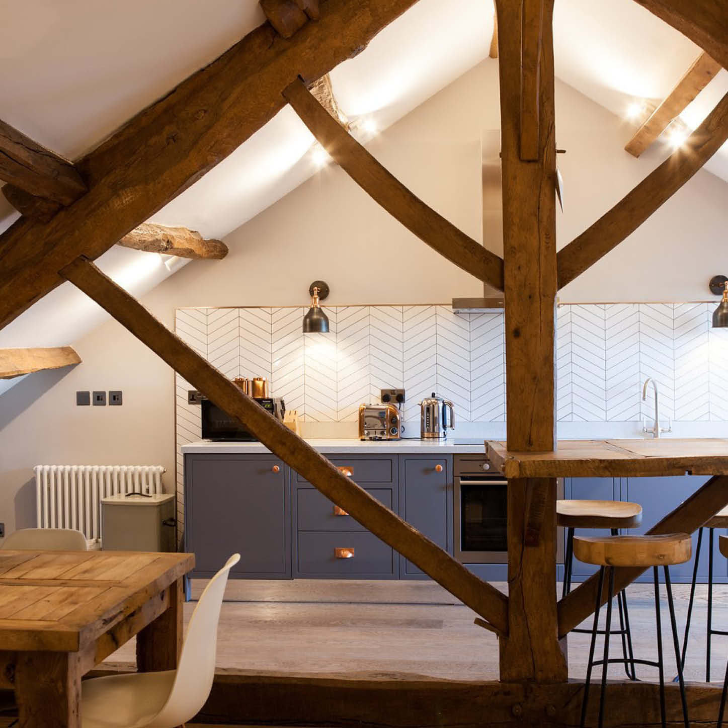 Natural materials with patterned wallpaper in a kitchen