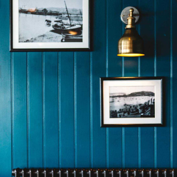 Vintage wall lights in a dramatic blue interior