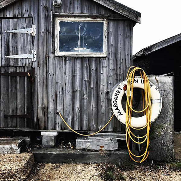 Rustic beach hut with life ring hanging outside