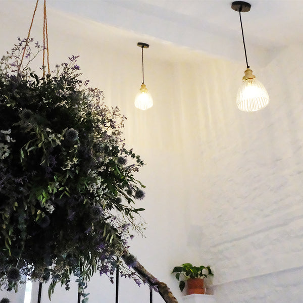 industrial style glass pendant lights in a hotel interior 