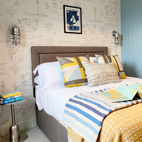 A nautical bedroom with bulkhead industrial lights by Industville