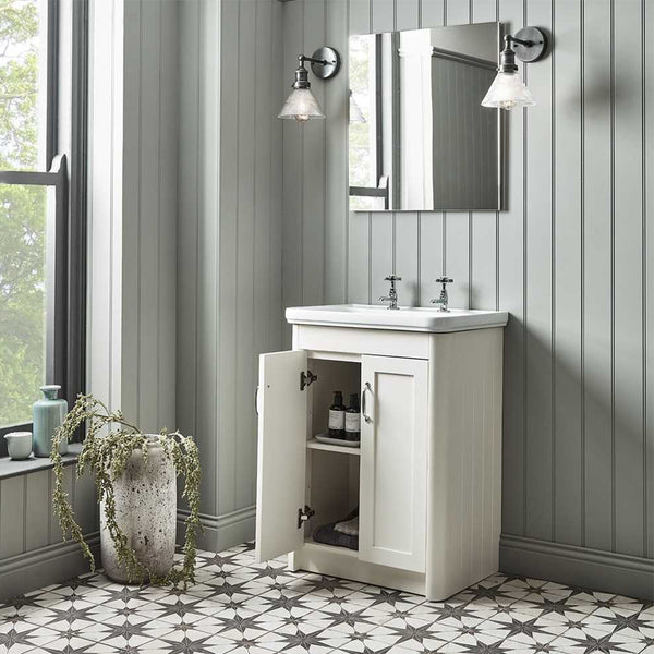 Bathroom interior with patterned tiled floor and vintage wall lights