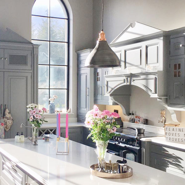 Spring kitchen interior with flowers and industrial lights