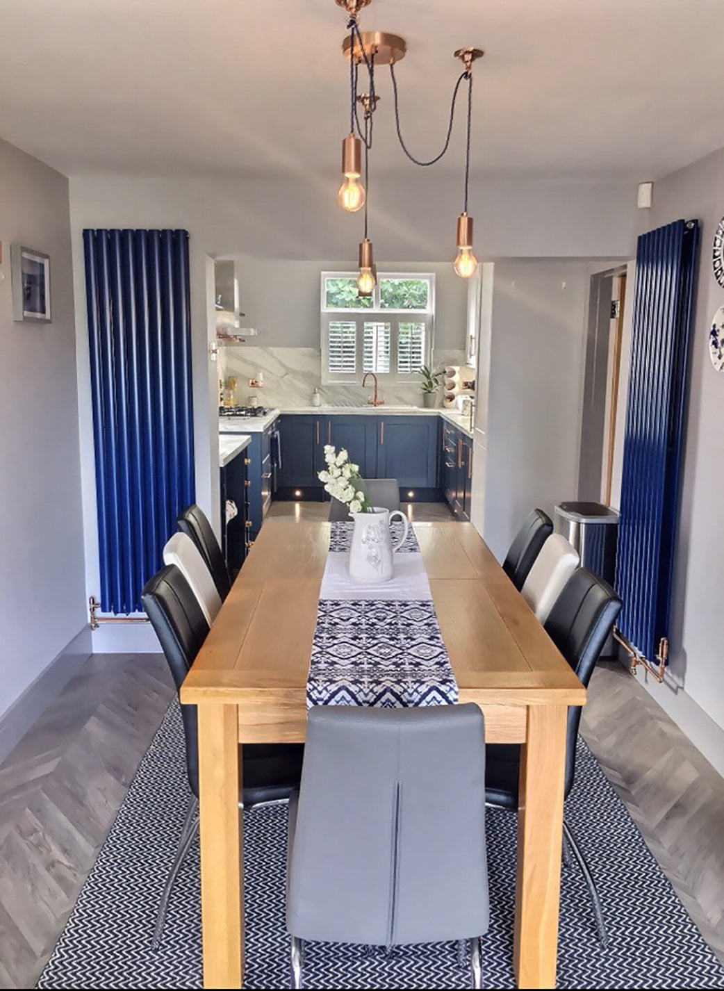 Industrial lights hanging above a dining table