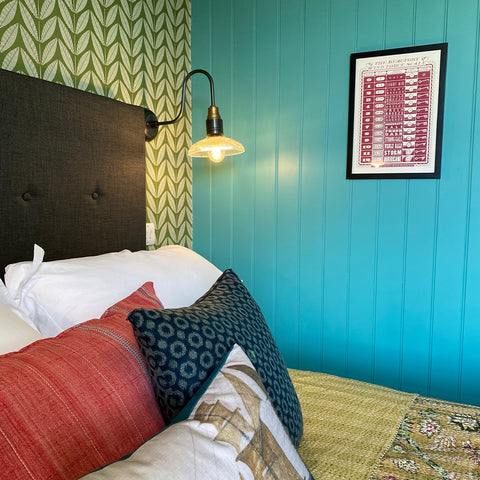 A bedroom with blue, nautical walls