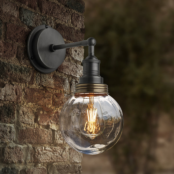 Pewter globe wall light on an outside brick wall