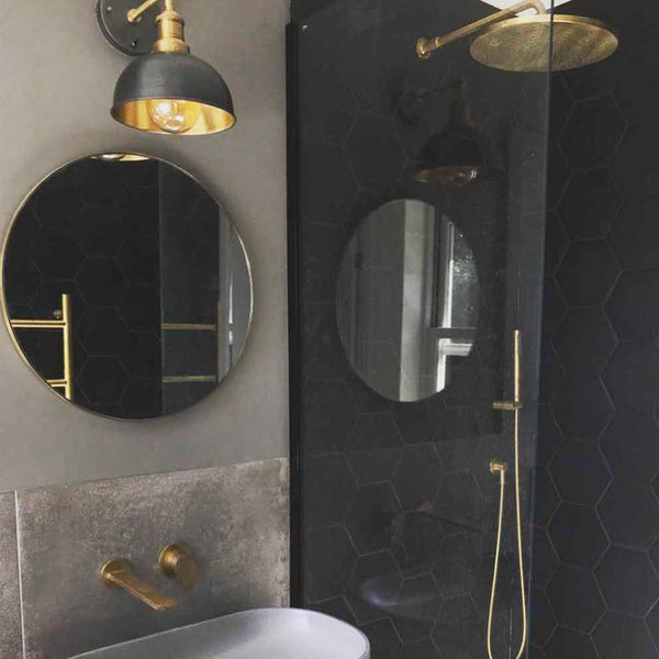 Dark bathroom interior with brass accessories