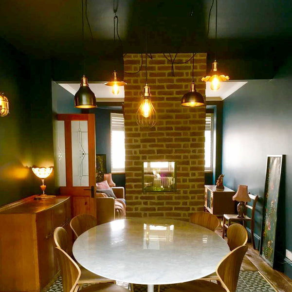 Modern chandelier placed over a dining room table