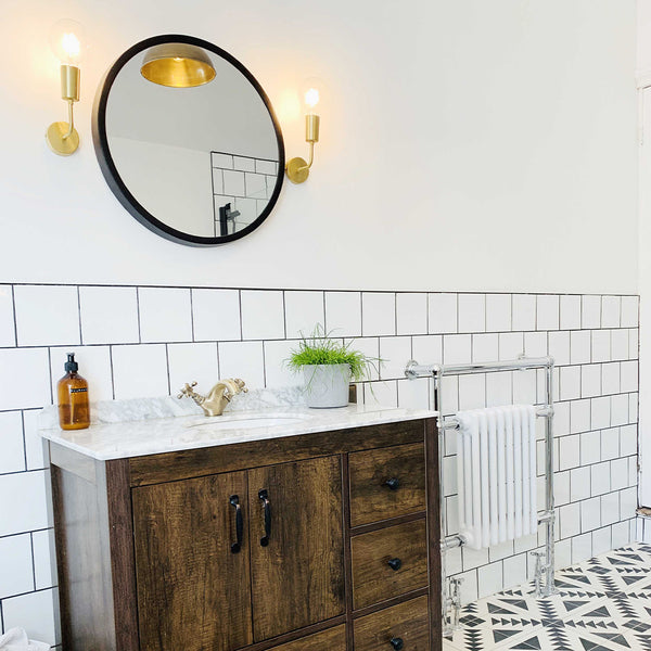 Mirror with candle lighting above bathroom sink