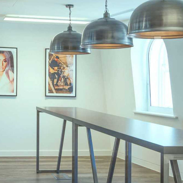 Trio of industrial pendants in an office setting