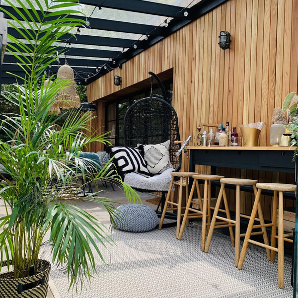 A comfy chair next to an outdoor bar