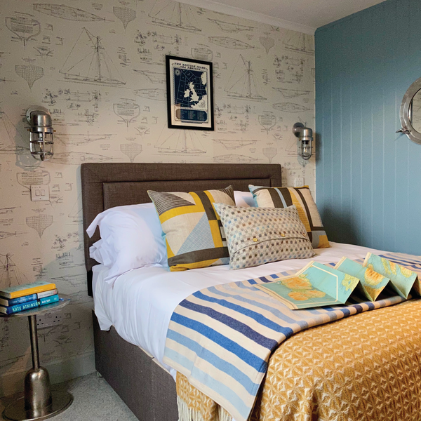 A nautical themed room decorated in blues and yellows