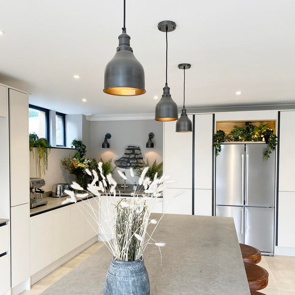 A modern kitchen interior with industrial lighting