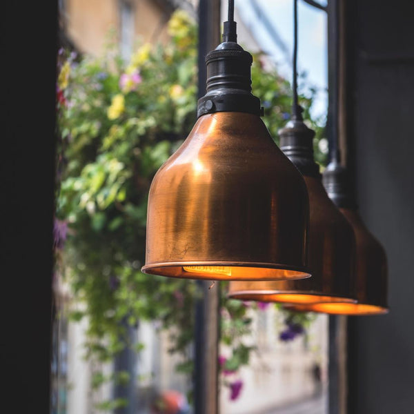 Hanging brass pendants in a window