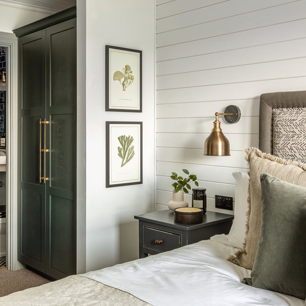 A bedroom decorated in greens, whites and golds