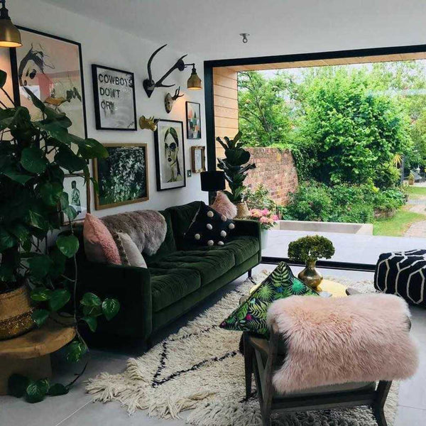 A gallery wall in a living room full of textured furnishings