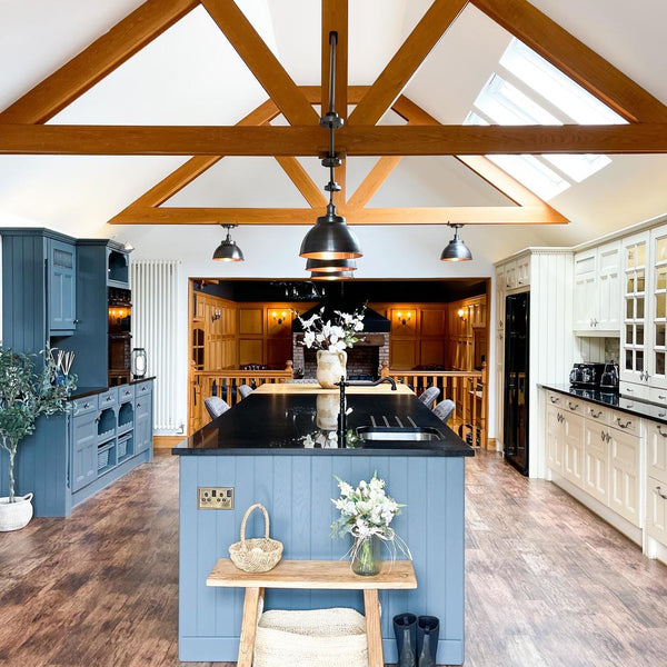 An inviting kitchen with wooden beams and pewter lights