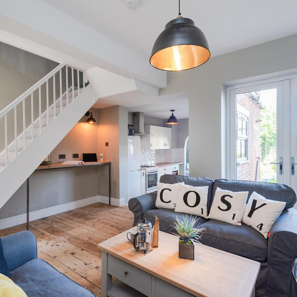 A living room with industrial-style lighting