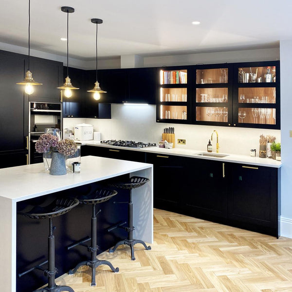 black and white kitchen with lights turned on