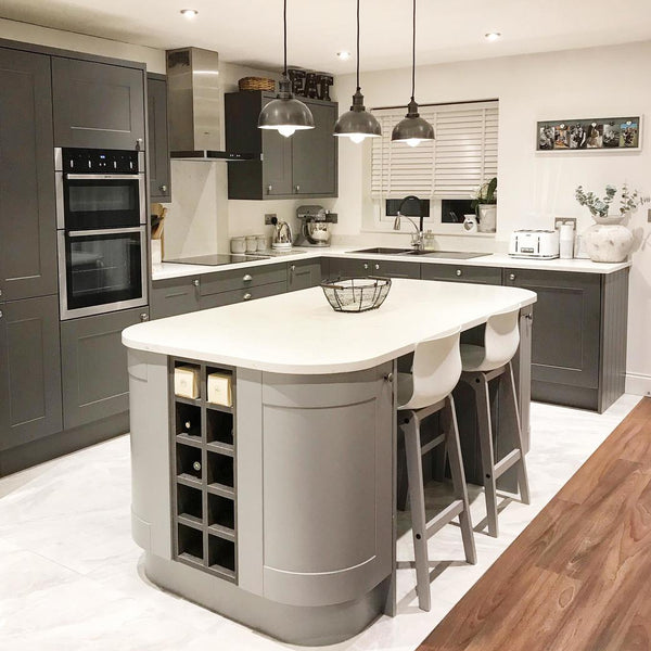 A grey industrial kitchen with with hanging pendants