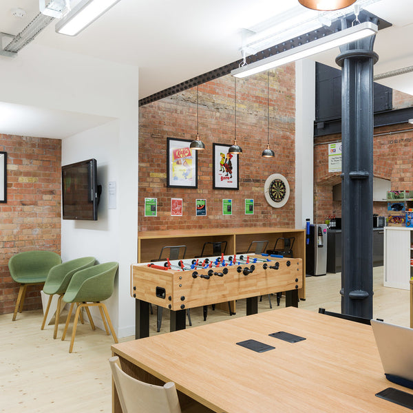 A modern business interior with exposed walls and wooden furnishings