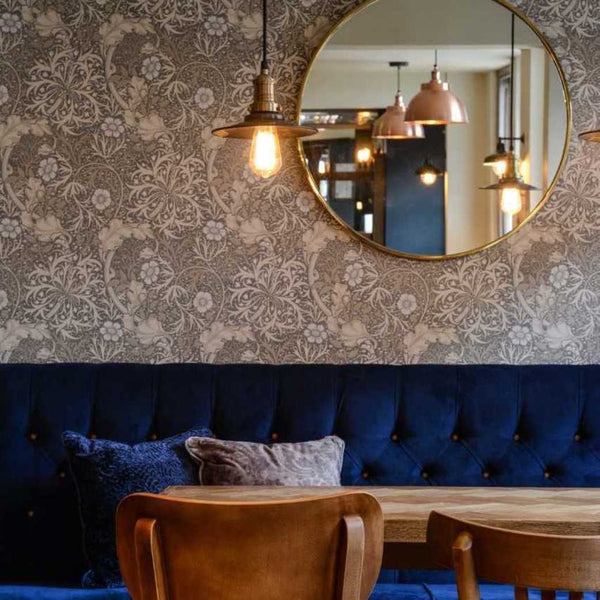 A luxurious dining area in a hotel with floral wallpaper